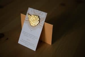 Image of a Giving Roses lapel pin and card.
