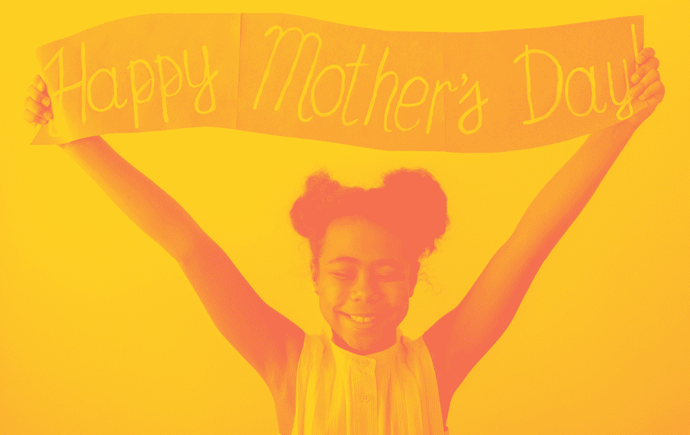 Girl holding Happy Mother's Day banner