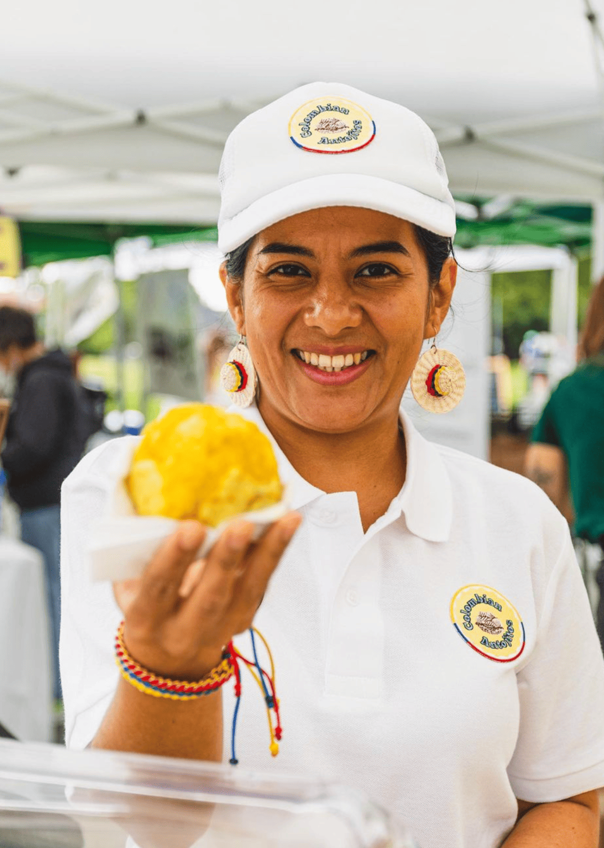 A Dream Cuisines program participant representing her food business at a market