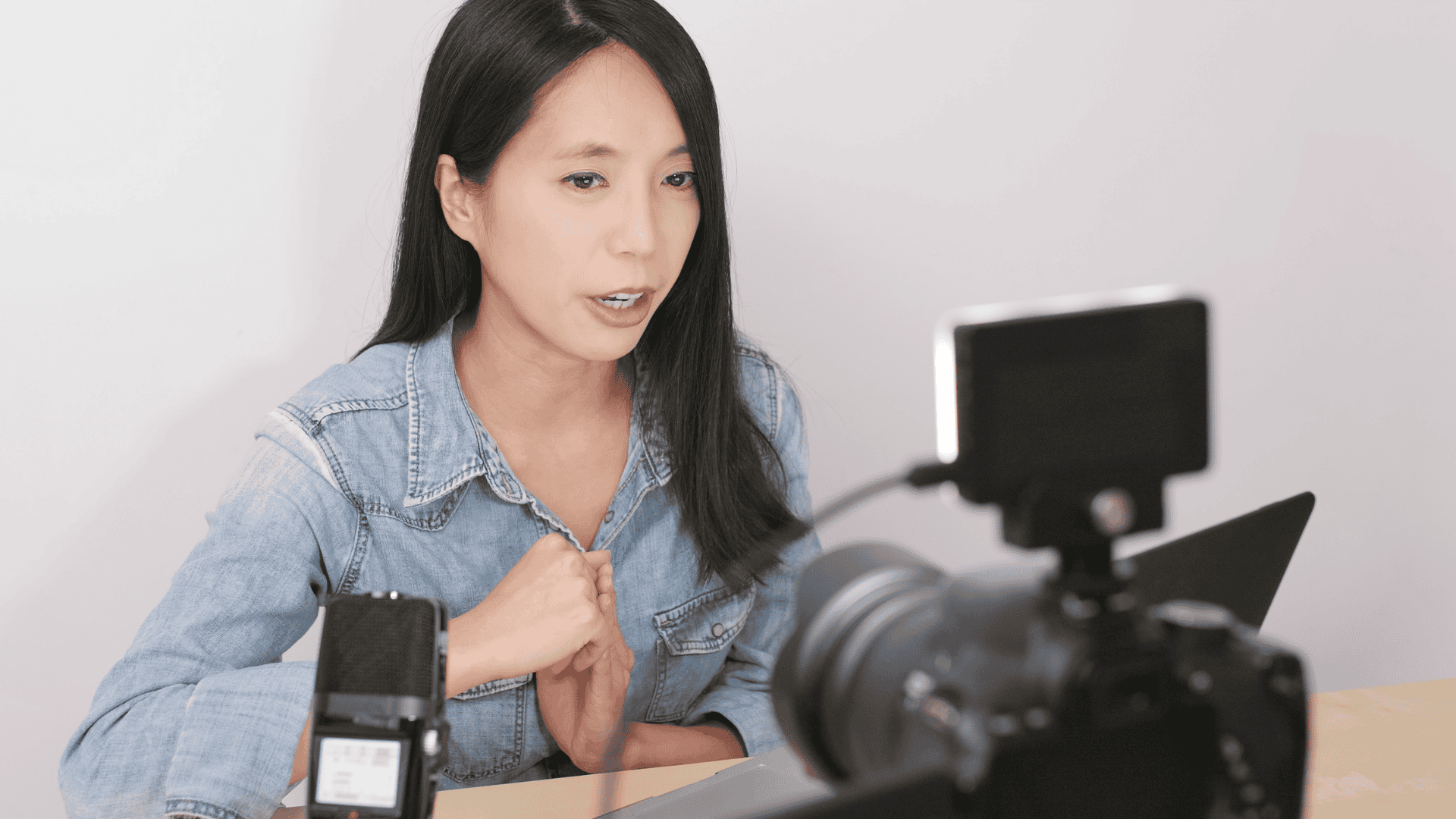 A woman content creator speaks to the camera while filming